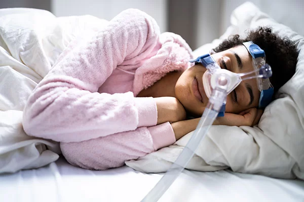 woman sleeping with cpap therapy