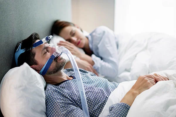 man using CPAP machine or BiPAP machine